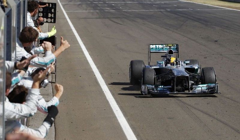 Cheered on by the Mercedes engineers at the chequered flag on his first victory with them